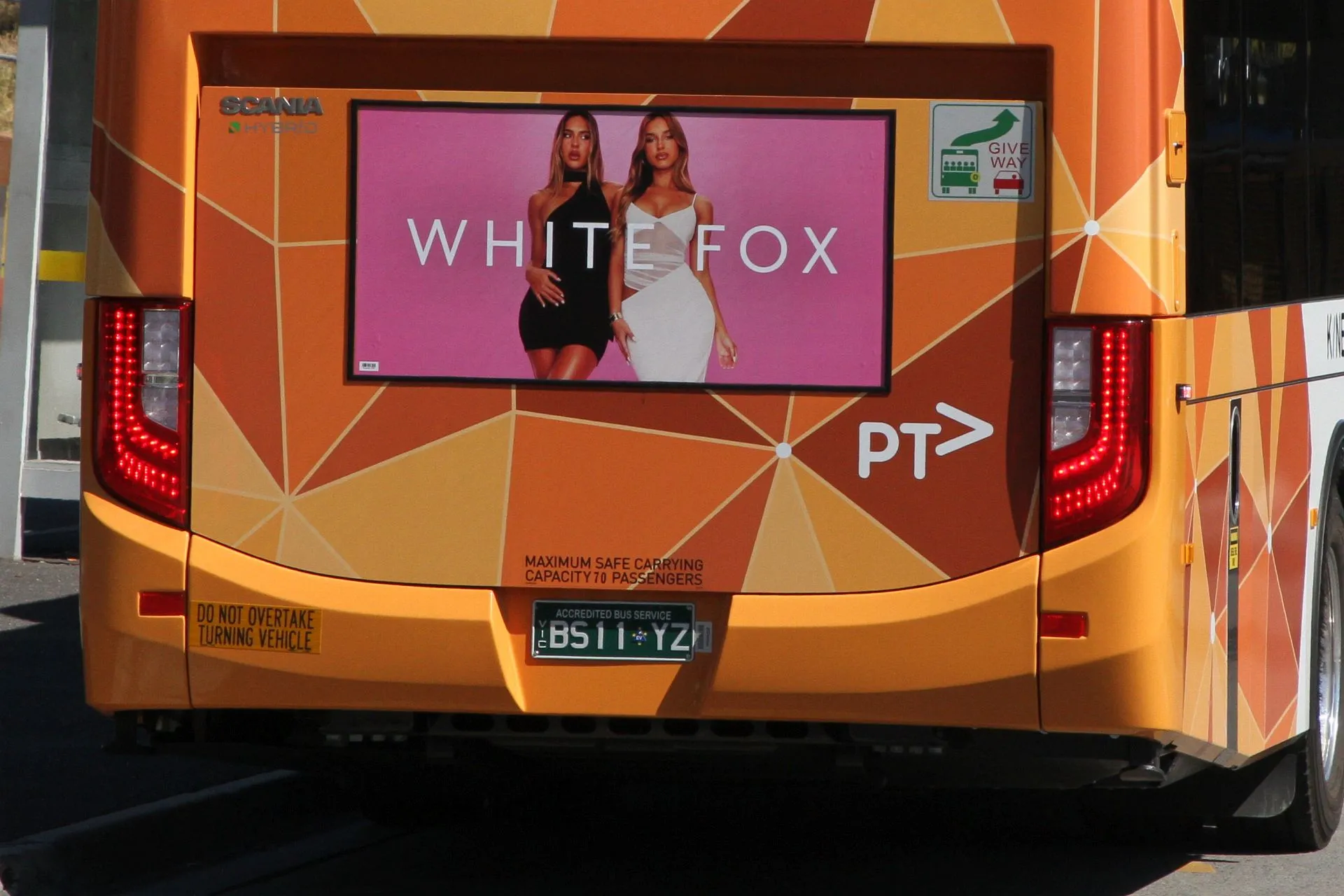 White Fox fast fashion ad on the back of a bus, with the brand’s recurring model.
